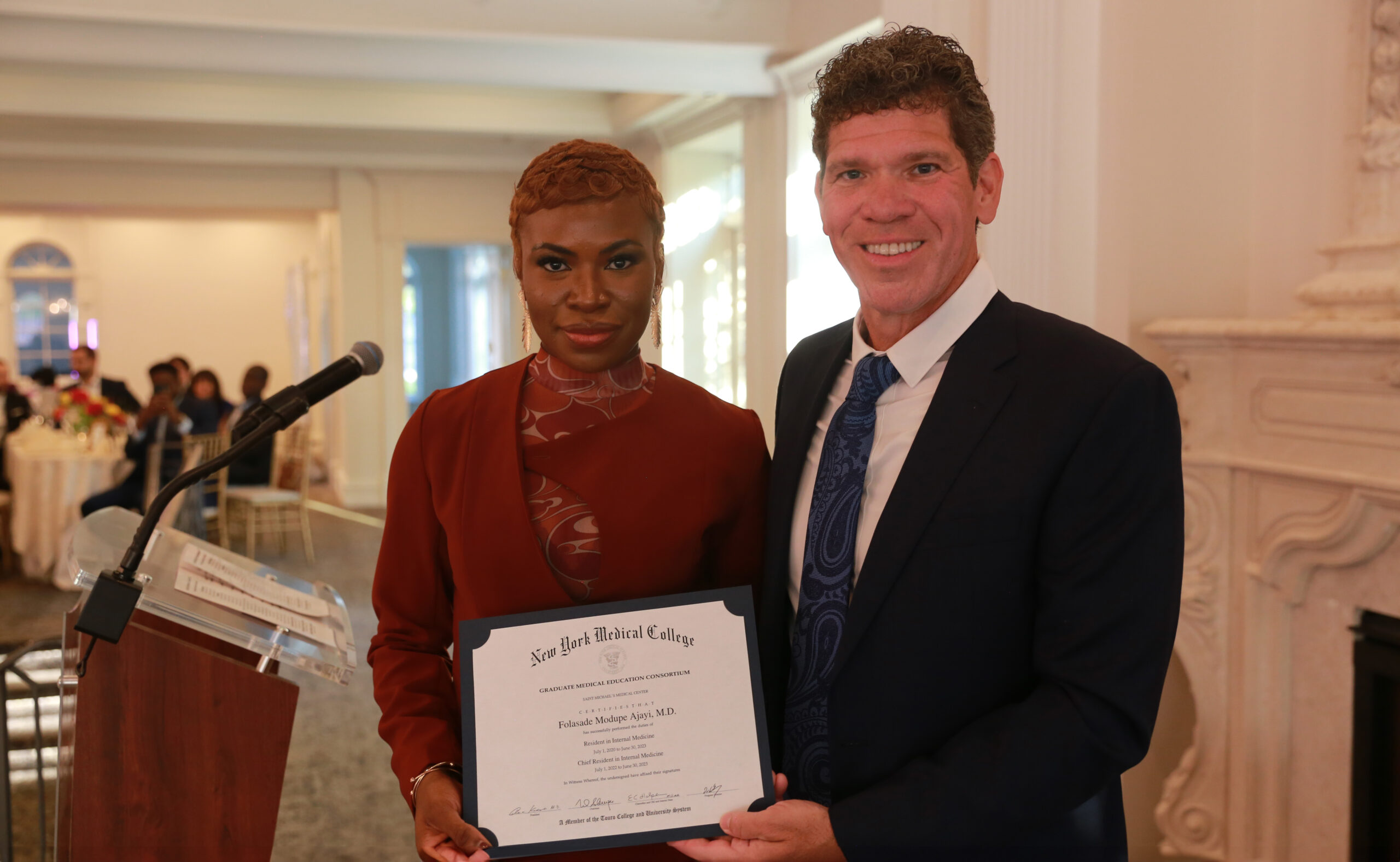 Folasade Ajayi, MD, poses with her certificate with Theodore DaCosta, director of Saint Michael’s residency program.