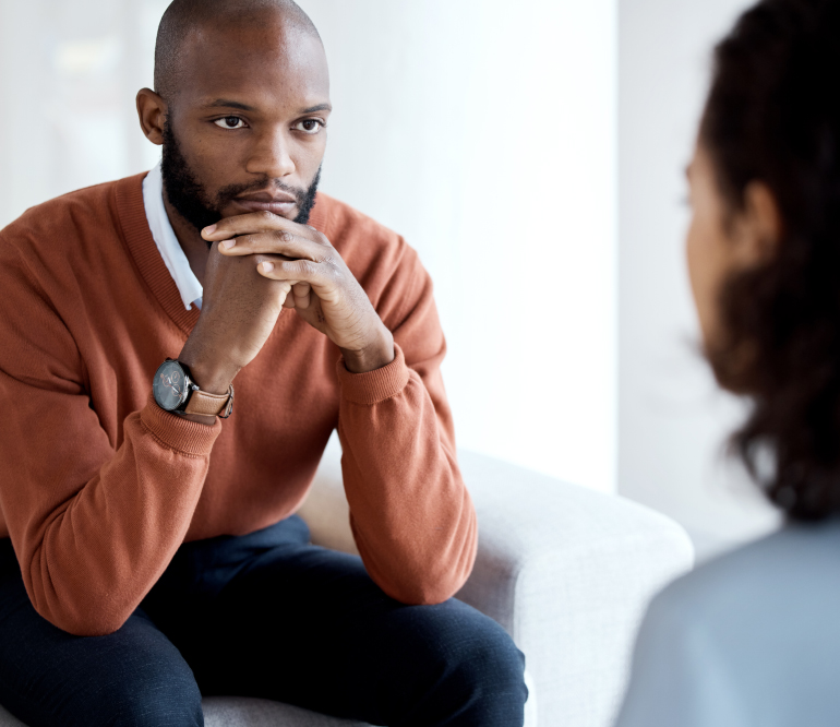 Mental health, depression and black man with a therapist for grief, depression or anxiety counseling. Psychology, sad and professional psychologist helping a African male patient in a clinic session.